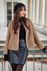 a lady wears an eco-friendly fur coat with a black turtle neck top